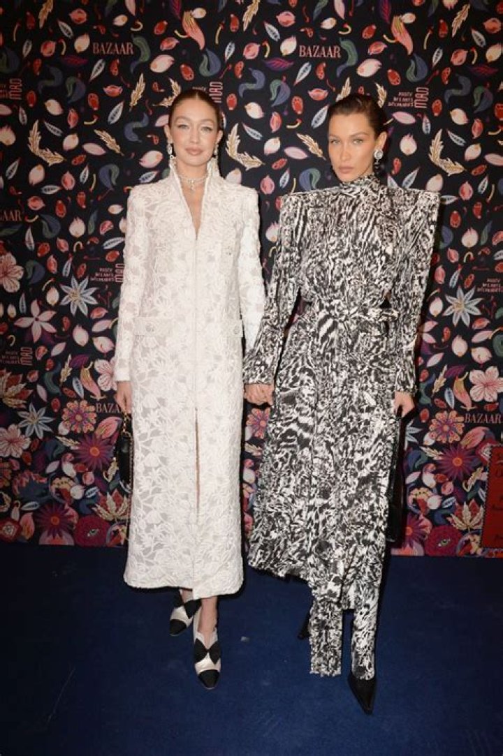 Gigi & Bella Hadid Hold Hands & Slay In Long Dresses At Paris Fashion Week Event – Pics